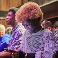 spectator messaging on their phone at a music event. - concert stock pictures, royalty-free photos & images