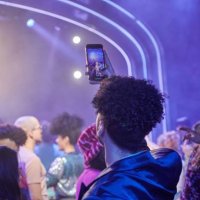 spectator recording a video with phone at a music event. - concert stock pictures, royalty-free photos & images