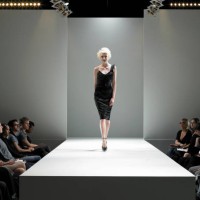 spectators watching fashion model on catwalk - fashion stock pictures, royalty-free photos & images