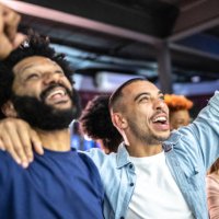 sports fans watching a match and celebrating at a bar - concert stock pictures, royalty-free photos & images