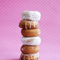 stack of donuts on pink background - junk food stock pictures, royalty-free photos & images