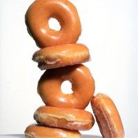 stack of glazed donuts - junk food stock pictures, royalty-free photos & images