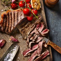 steak cut on board with roasted veg - food stock pictures, royalty-free photos & images