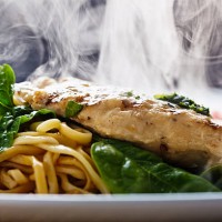 steaming seared chicken breast with pesto, noodles and spinach - food stock pictures, royalty-free photos & images