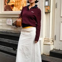 Steph Hui is seen wearing a maroon Miu Miu shirt, white Miu Miu skirt, yellow Miu Miu shorts, brown Miu Miu bag and black sneakers on September 05,...