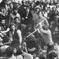 Still from the documentary film 'Gimme Shelter', showing audience members looking on as Hells Angels beat a fan with pool cues at the Altamont Free...