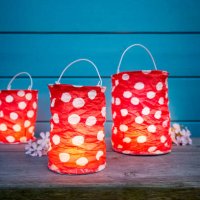 still life of dotted red paper lanterns for party decoration in front of blue wooden wall in the evening - garden decoration stock pictures, royalty-free photos & images