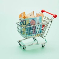 still life of shopping cart and euro notes on turquoise background - food stock pictures, royalty-free photos & images