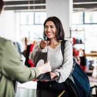 store clerk handing customer purchased items - fashion stock pictures, royalty-free photos & images