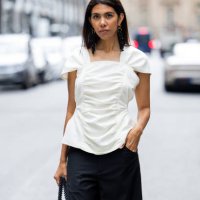 Storm Westphal-Knieling wears white blouse, black wide leg pants, bag outside William Fan during the Berlin Fashion Week SS25 on July 03, 2024 in...