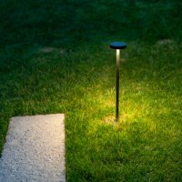 street lamps on the lawn illuminate the road. - garden decoration stock pictures, royalty-free photos & images