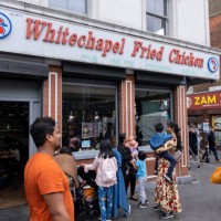 Street scene on Whitechapel High Street as Whitechapel Fried Chicken has it's old sign changed on 22nd August 2022 in London, United Kingdom....