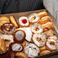street vendor carrying box of doughnuts, mid section, elevated view - junk food stock pictures, royalty-free photos & images
