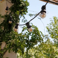 string of light bulbs at terrace - garden decoration stock pictures, royalty-free photos & images