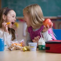 students eating lunch in classroom - junk food stock pictures, royalty-free photos & images