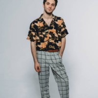 studio portrait of a young adult man against a gray background - fashion stock pictures, royalty-free photos & images