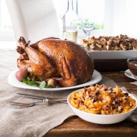 stuffing, sweet potatoes and smoked turkey on wooden table - food stock pictures, royalty-free photos & images