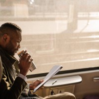 stylish businessman with reusable cup and documents in a train - junk food stock pictures, royalty-free photos & images