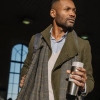 stylish man with reusable cup getting out of the train station - junk food stock pictures, royalty-free photos & images