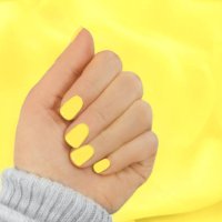 stylish trendy yellow manicure on illuminating yellow colour silk scarf background. - nails art stock pictures, royalty-free photos & images