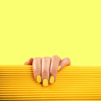 stylish trendy yellow manicure on yellow and orange color background. - nails art stock pictures, royalty-free photos & images