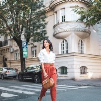 stylish woman crossing city street in fashionable attire - fashion stock pictures, royalty-free photos & images