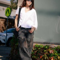 Su Shan Leong wearing Y/Project denim pants, Facetasm white shirt, Maison Margiela Tabis and Lamaire bag during Australian Fashion Week Presented By...