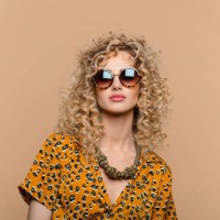 summer portrait of curly hair woman in leopard print dress - fashion stock pictures, royalty-free photos & images