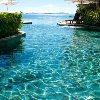 sun lounges beside a pool with ocean - home decoration stock pictures, royalty-free photos & images