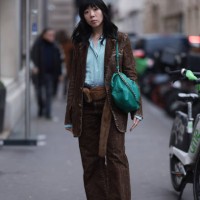 Susie Lau seen wearing green / white striped buttoned shirt, brown denim blazer jacket, matching brown denim / jeans wide leg pants, brown fluffy...