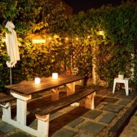table with candle lights in backyard garden in evening - garden decoration stock pictures, royalty-free photos & images