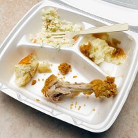 take-out container with eaten fried chicken dinner - junk food stock pictures, royalty-free photos & images
