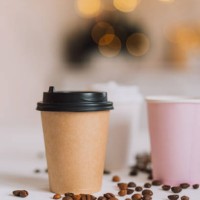 takeaway coffee in tray on white table with coffee beans against tree lights - junk food stock pictures, royalty-free photos & images