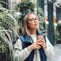 takeaway coffee young woman drinking hot coffee or tea from paper coffee cup outdoors - junk food stock pictures, royalty-free photos & images