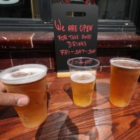 Takeaway pints of beer outside Charrington's Noted Ales And Stout pub in London, as further coronavirus lockdown restrictions are lifted in England.
