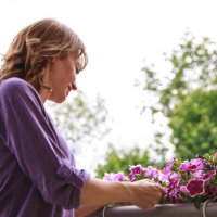 taking care of her plants in the balcony - garden decoration stock pictures, royalty-free photos & images