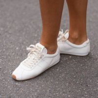 Tamara Kalinic wears white leather Miu Miu sneakers shoes, outside Miu Miu, during the Paris Fashion week Women's Fall/Winter 2025-2026 on March 11,...