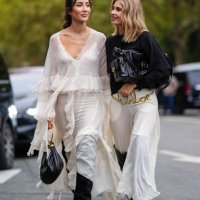 Tamara Kalinic white flowy ruffled long sleeve Chloe midi dress, black leather Chloe bag, black heeled thigh high Chloe boots. Xenia Adonts wears...