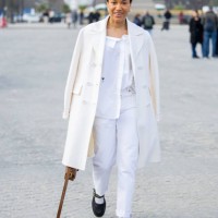 Tamu McPherson wears white coat, pants, shirt, brown bag outside Dior during the Womenswear Fall/Winter 2025/2026 as part of Paris Fashion Week on...