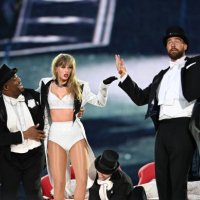 Taylor Swift is joined on stage by Travis Kelce , during 