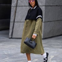 Tayshia Adams wears Longchamp green black coat, bag, shoes during New York Fashion Week on September 09, 2024 in New York City.