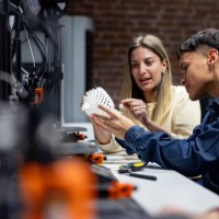 team of engineering students looking at a 3d printing model in class - fashion stock pictures, royalty-free photos & images