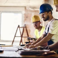 team of manual workers examining housing project while working at construction site. - home decoration stock pictures, royalty-free photos & images