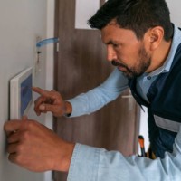 technician installing an alarm system in a smart home - home decoration stock pictures, royalty-free photos & images