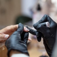 technician painting the nails of a client - nails art stock pictures, royalty-free photos & images
