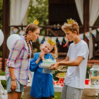 teen kids are posing near decorated birthday table. blowing the candle - garden decoration stock pictures, royalty-free photos & images