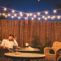 teen resting in the backyard patio listening to music - covid-19 series - garden decoration stock pictures, royalty-free photos & images