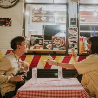 teenage boy introduce himself in front of camera with a hamburger for dining - stock photo - junk food stock pictures, royalty-free photos & images