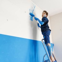 teenage boy making mistake while painting the room - home decoration stockfoto's en -beelden