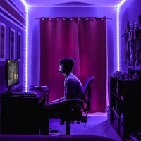 teenage boy playing video game at desk in room with neon led lighting. - home decoration stock pictures, royalty-free photos & images